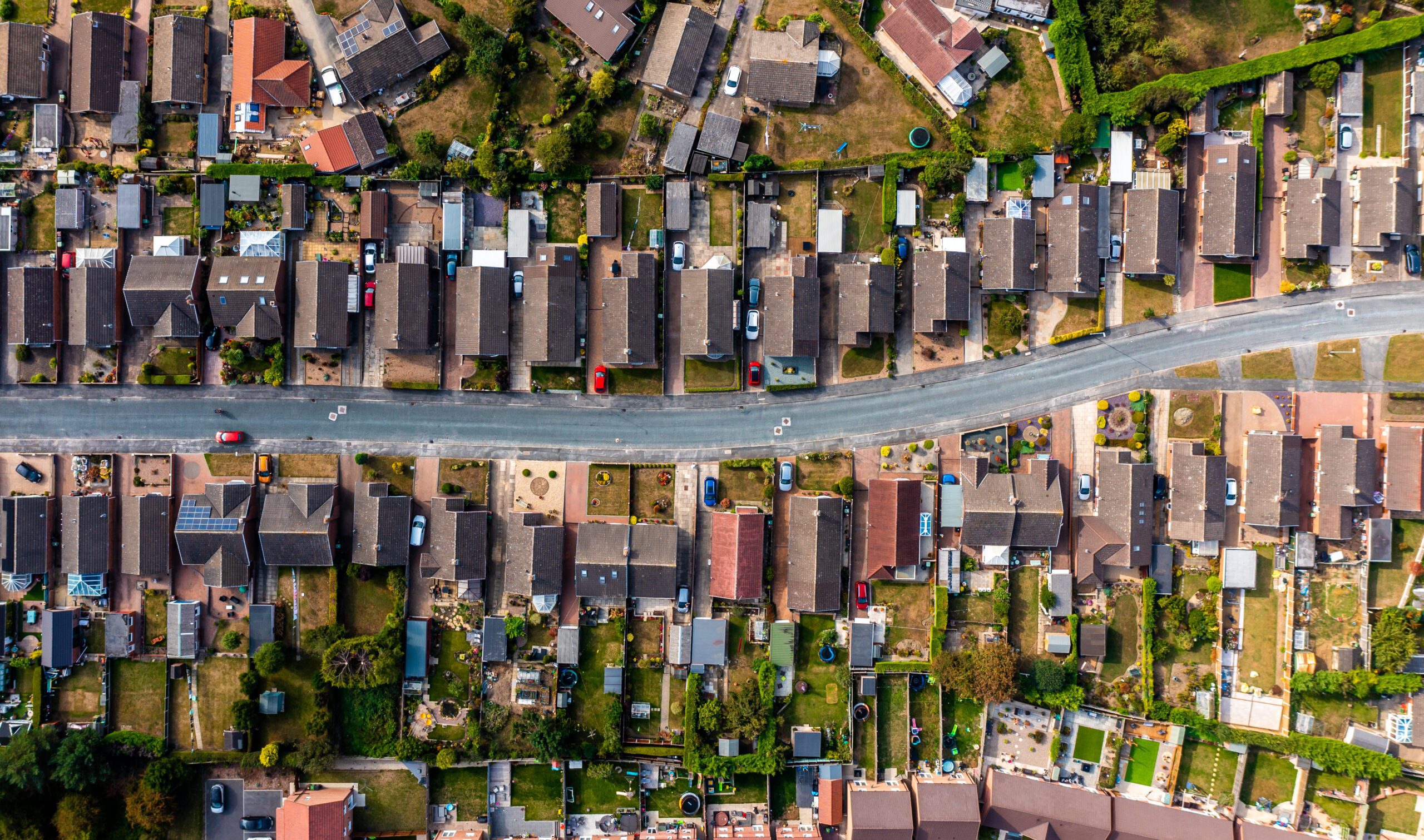 Aerial view directly above a road through a suburban housing est